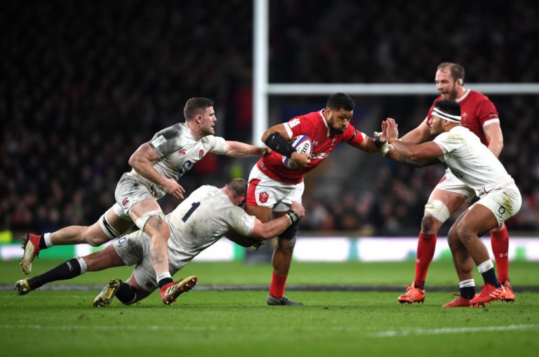 Rugby players contest contact during a match as World Rugby prepares tackle-height law changes